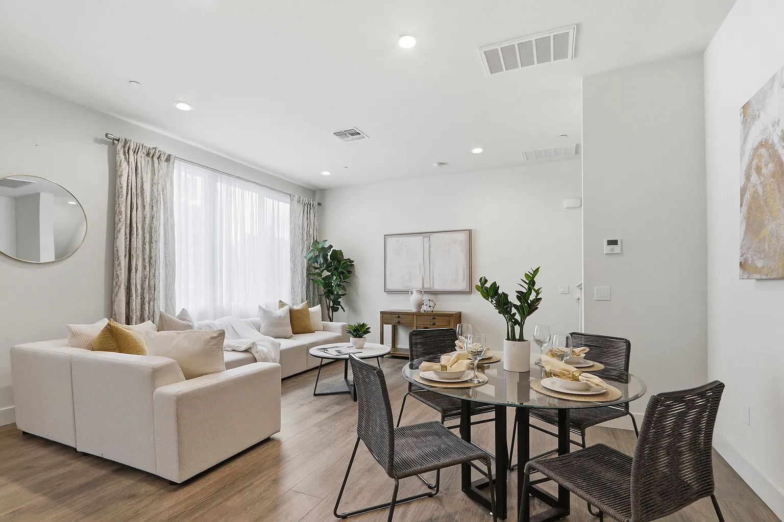 Dining table set for four beside the living area